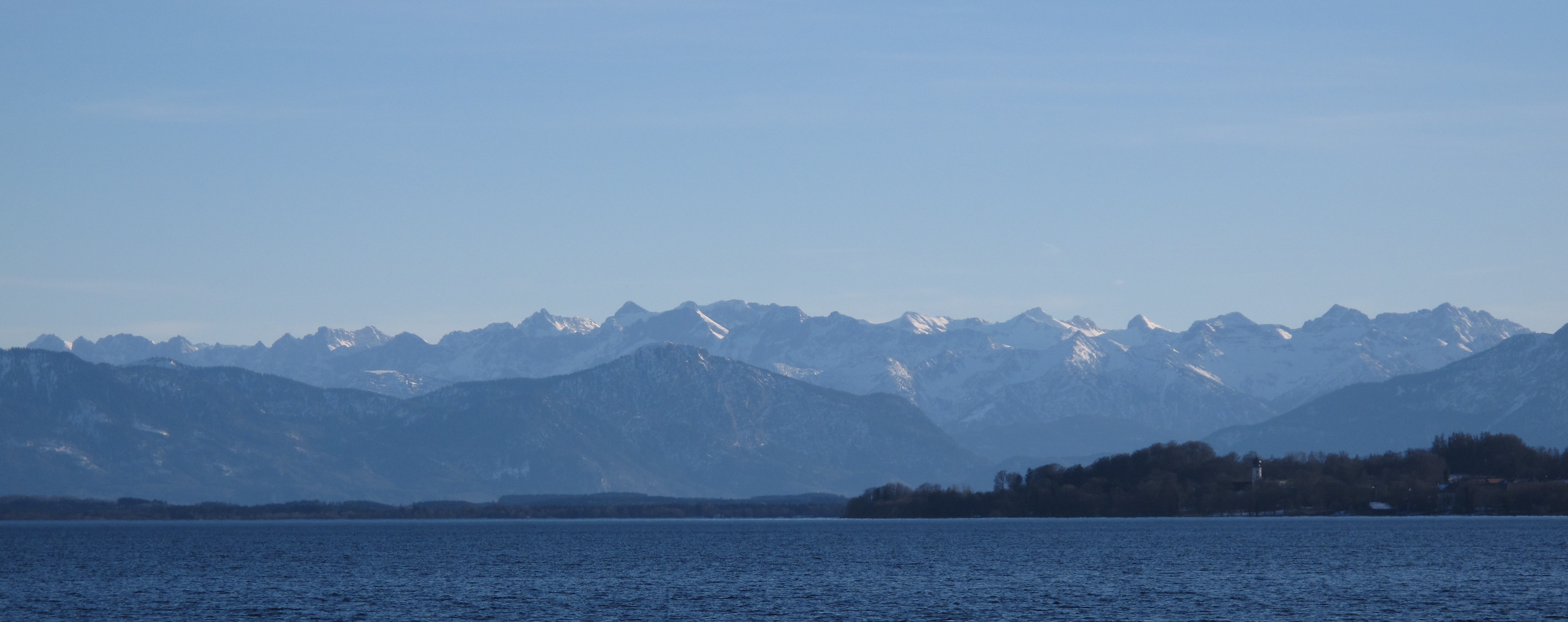 Blue water of Lake Starnberg with the Bavarian Alps beyond
